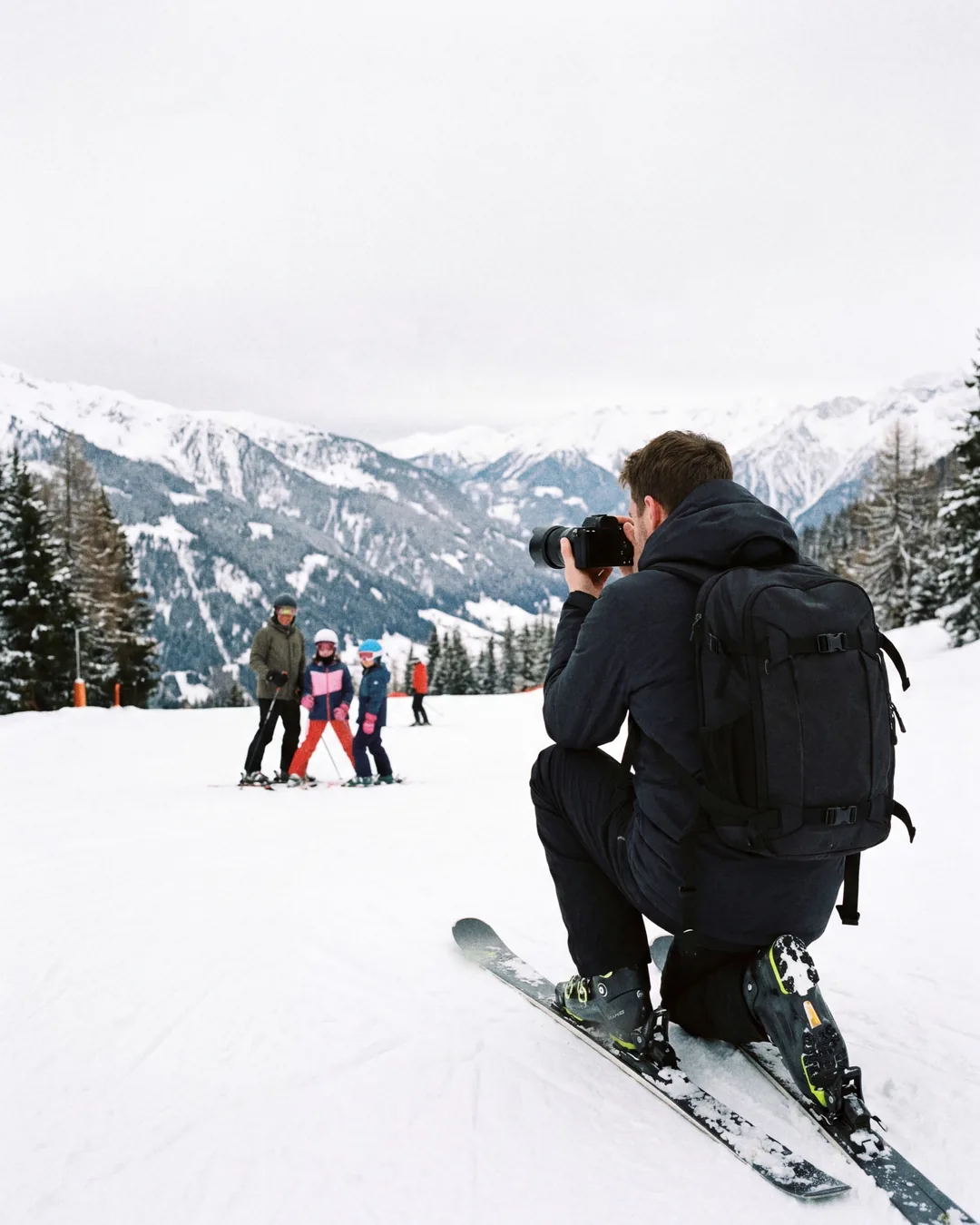 Photographer on skis framing a skier below